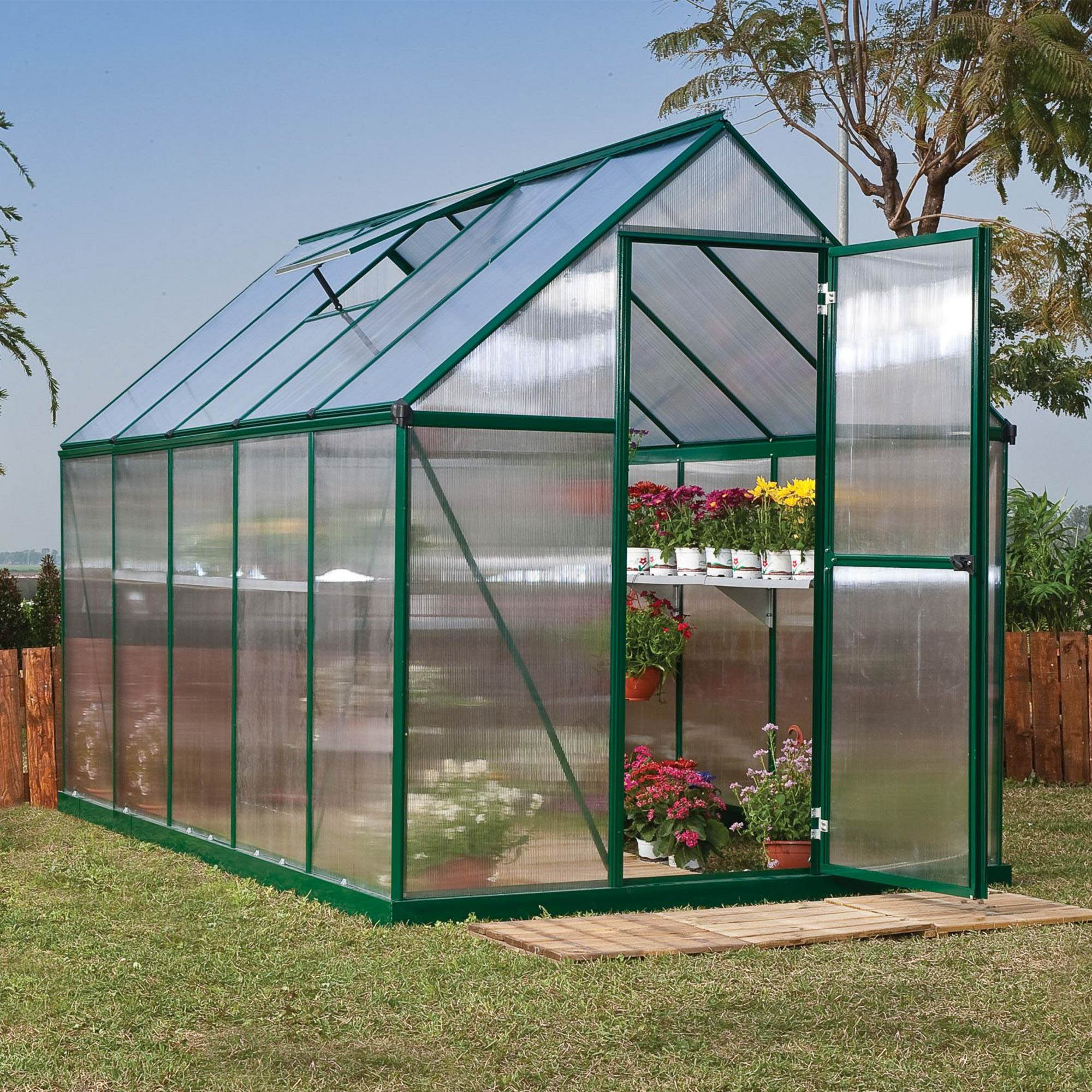 A large greenhouse made up of windows with green framing