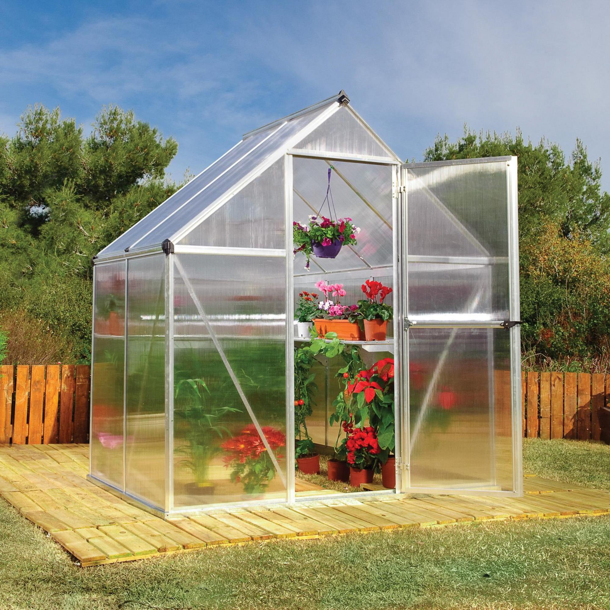 A greenhouse made up of windows with silver metal framing