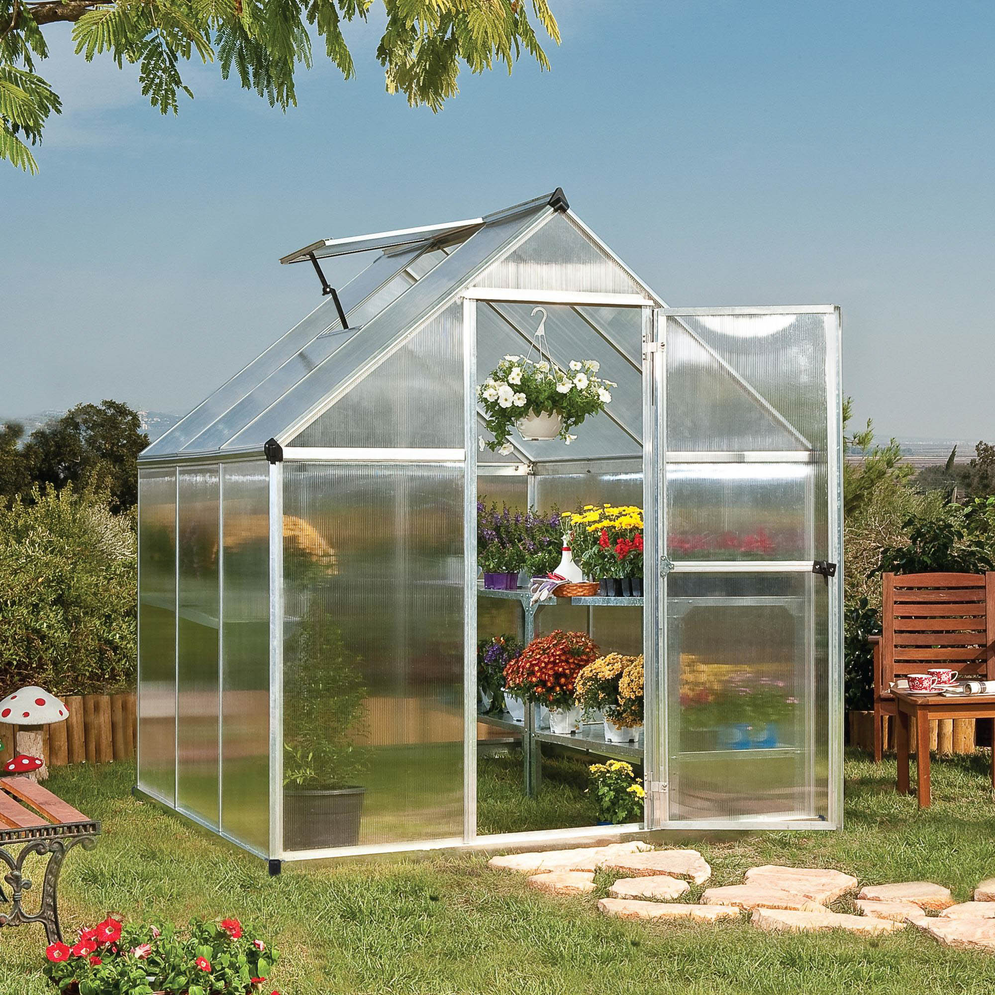 A greenhouse with textured windows and silver metal framing