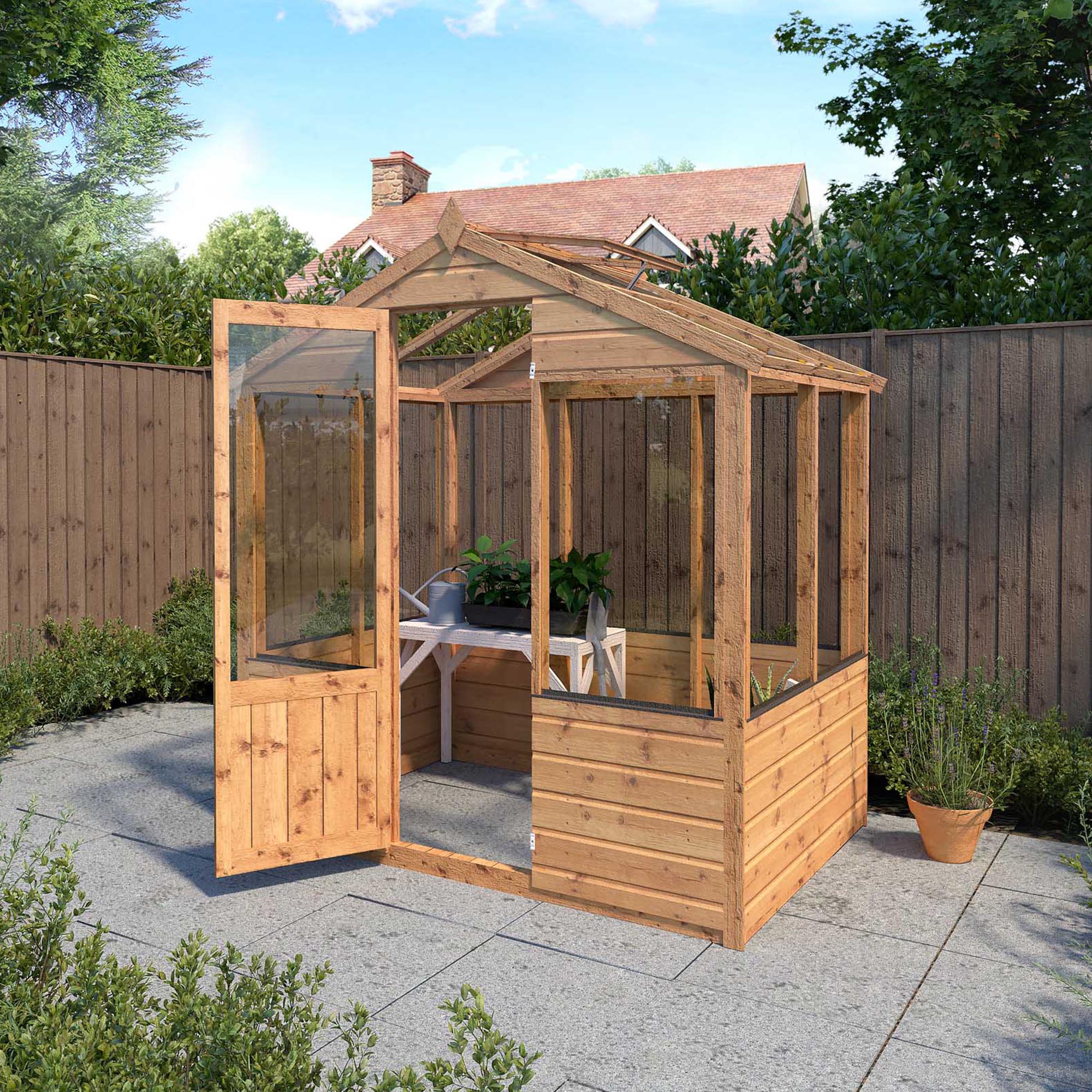 a timber greenhouse with an open door